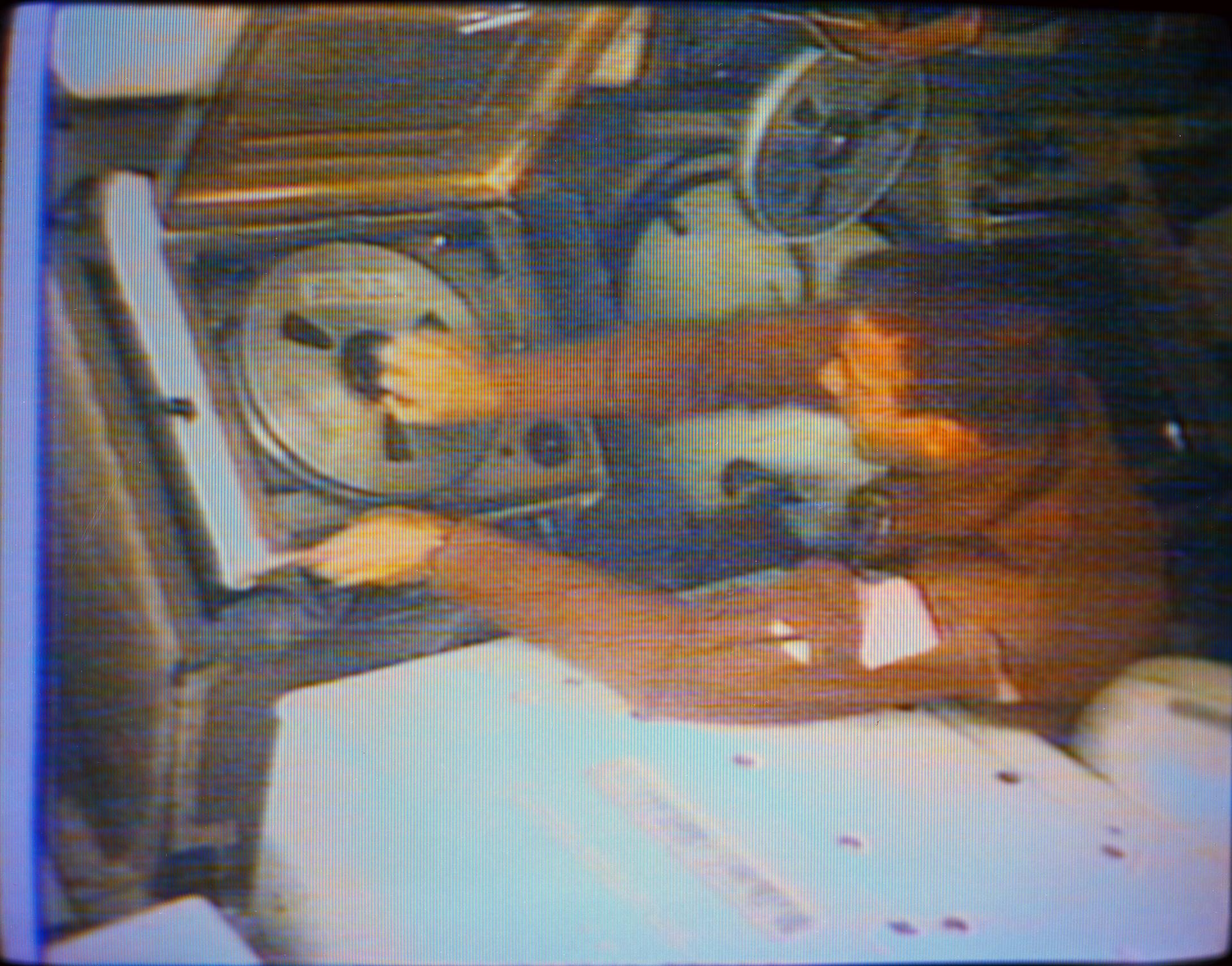 Skylab 2 pilot Paul Weitz changes the tape in the Skylab video tape recorder in this still created from a TV transmission.