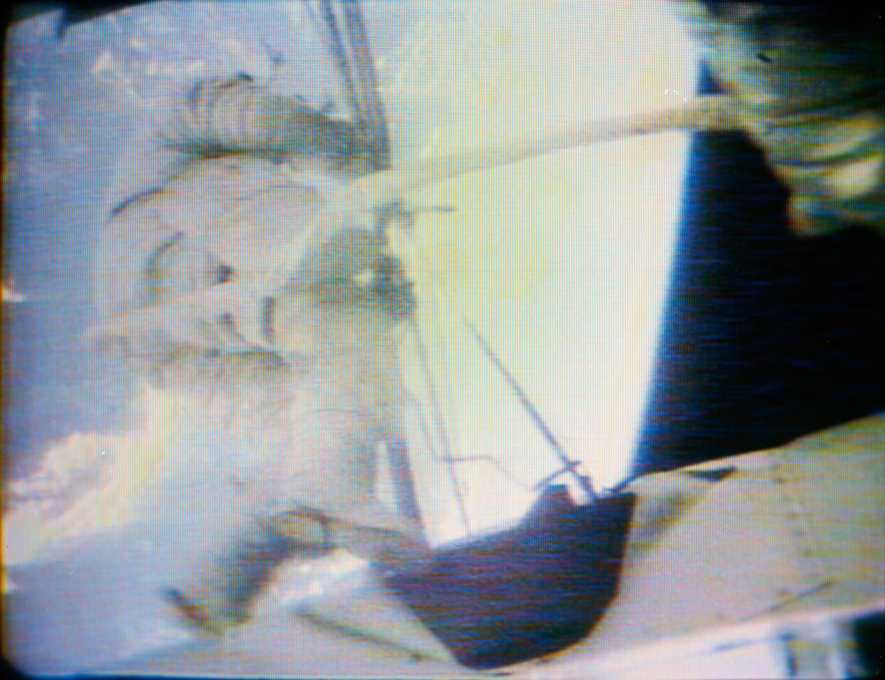 S73-27734 (11 June 1973) --- Skylab 2 astronaut performs extravehicular activity (EVA) at the Skylab 1 and 2 space station cluster in Earth orbit, as seen in this reproduction taken from a color television transmission made by a TV camera aboard the station. Kerwin is just outside the Airlock Module. Photo credit: NASA