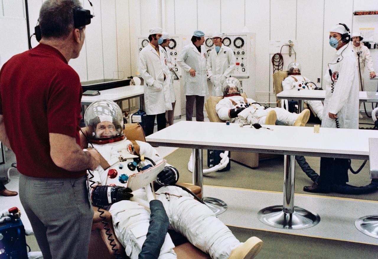 S73-31800 (28 July 1973) --- The three crewmen of the second manned Skylab mission (Skylab 3) participate in prelaunch suiting up activities in the Manned Spacecraft Operations Building at the Kennedy Space Center on the morning of the Skylab 3 launch. They are (from foreground) astronaut Alan L. Bean, commander; scientist-astronaut Owen K. Garriott, science pilot; and astronaut Jack R. Lousma, pilot.  Dr. Donald K. Slayton (left foreground), Director of Flight Crew Operations, Johnson Space Center, monitors the prelaunch activities. Skylab 3 lifted off at 7:11 a.m. (EDT), Saturday, July 28, 1973. The three astronauts were scheduled to spend 59 days at the Skylab space station in Earth orbit. Photo credit: NASA