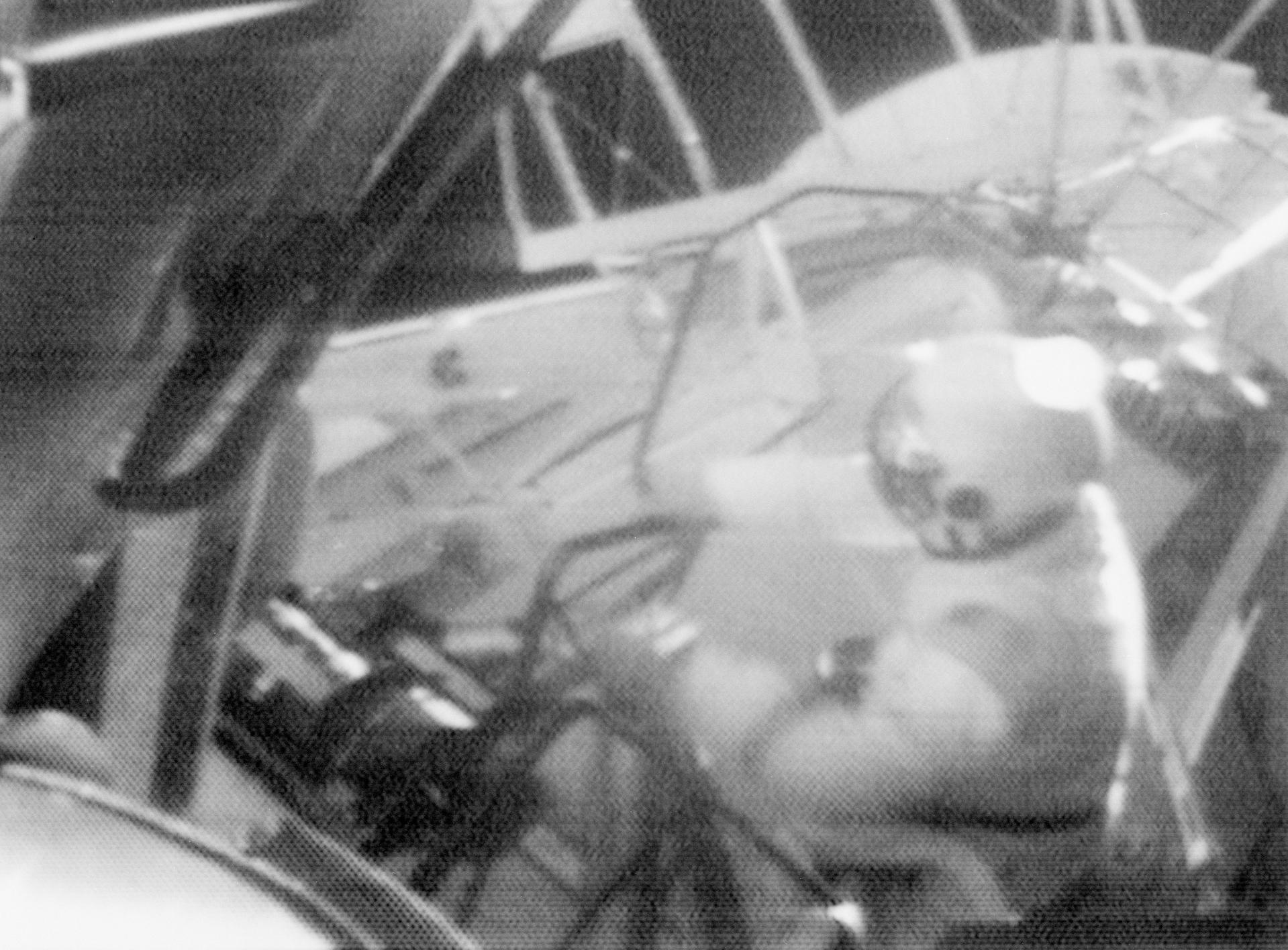 Grainy black and white image of Jack Lousma during a spacewalk for the Skylab 3 mission