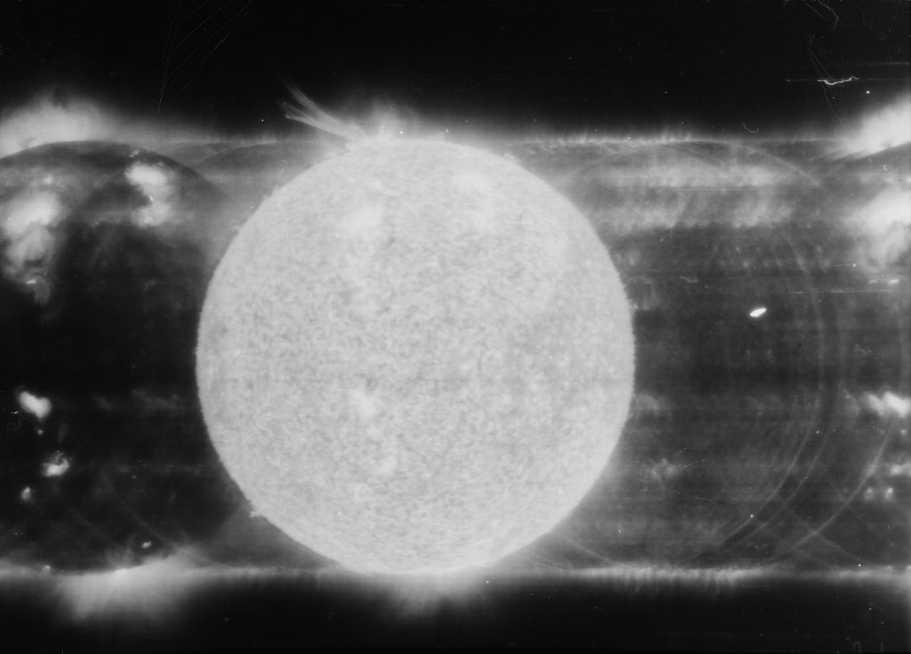 S73-33788 (10 June 1973) --- The solar eruption of June 10, 1973, is seen in this spectroheliogram obtained during the first manned Skylab mission (Skylab 2), with the SO82A experiment, an Apollo Telescope Mount (ATM) component covering the wavelength region from 150 to 650 angstroms (EUV). The solid disk in the center was produced from 304 angstrom ultraviolet light from He + ions. At the top of this image a great eruption is visible extending more than one-third of a solar radius from the sun's surface. This eruption preceded the formation of an enormous coronal bubble which extended a distance of several radii from the sun's surface, and which was observed with the coronagraph aboard Skylab. In contrast, the Fe XV image at 285 angstrom just to the right of the 304 angstrom image does not show this event. Instead, it shows the bright emission from a magnetic region in the lower corona. In this picture, solar north is to the right, and east is up.  The wavelength scale increases to the left.  The U.S. Naval Research Laboratory is principal investigator in charge of the SO82 experiment. Photo credit: NASA