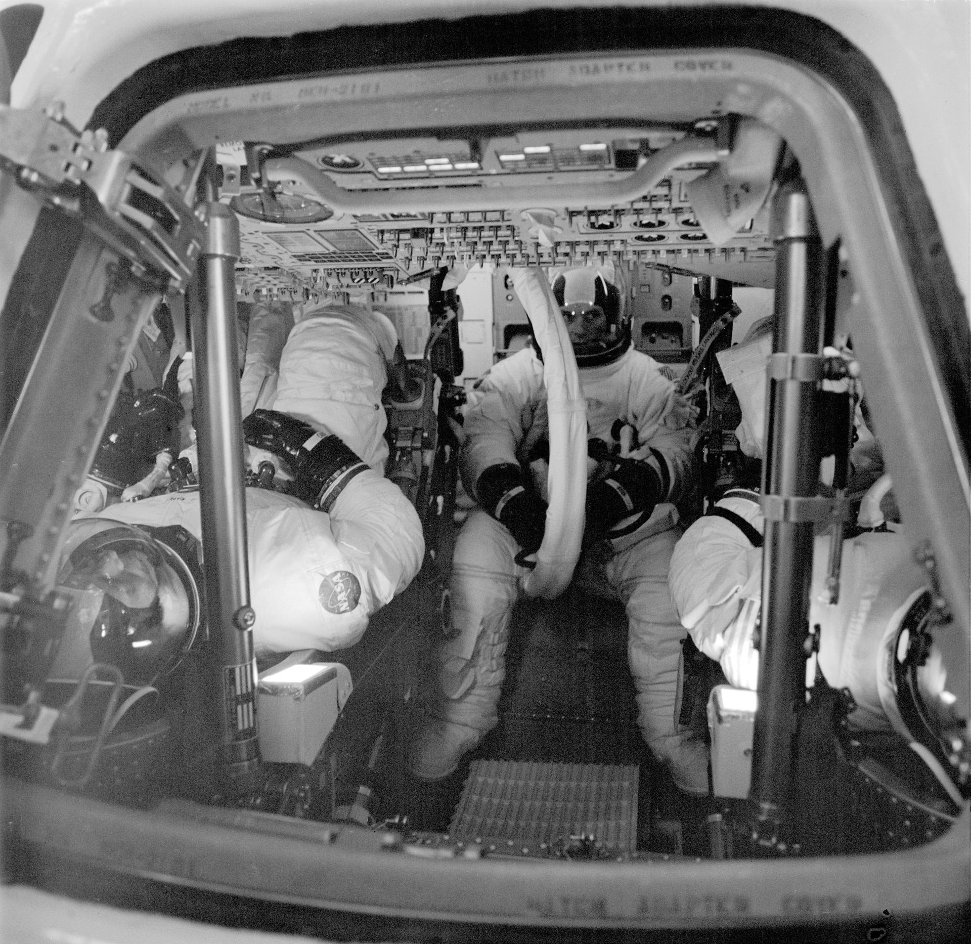 The three astronauts for Skylab 4 are shown seated inside the Apollo Command Module