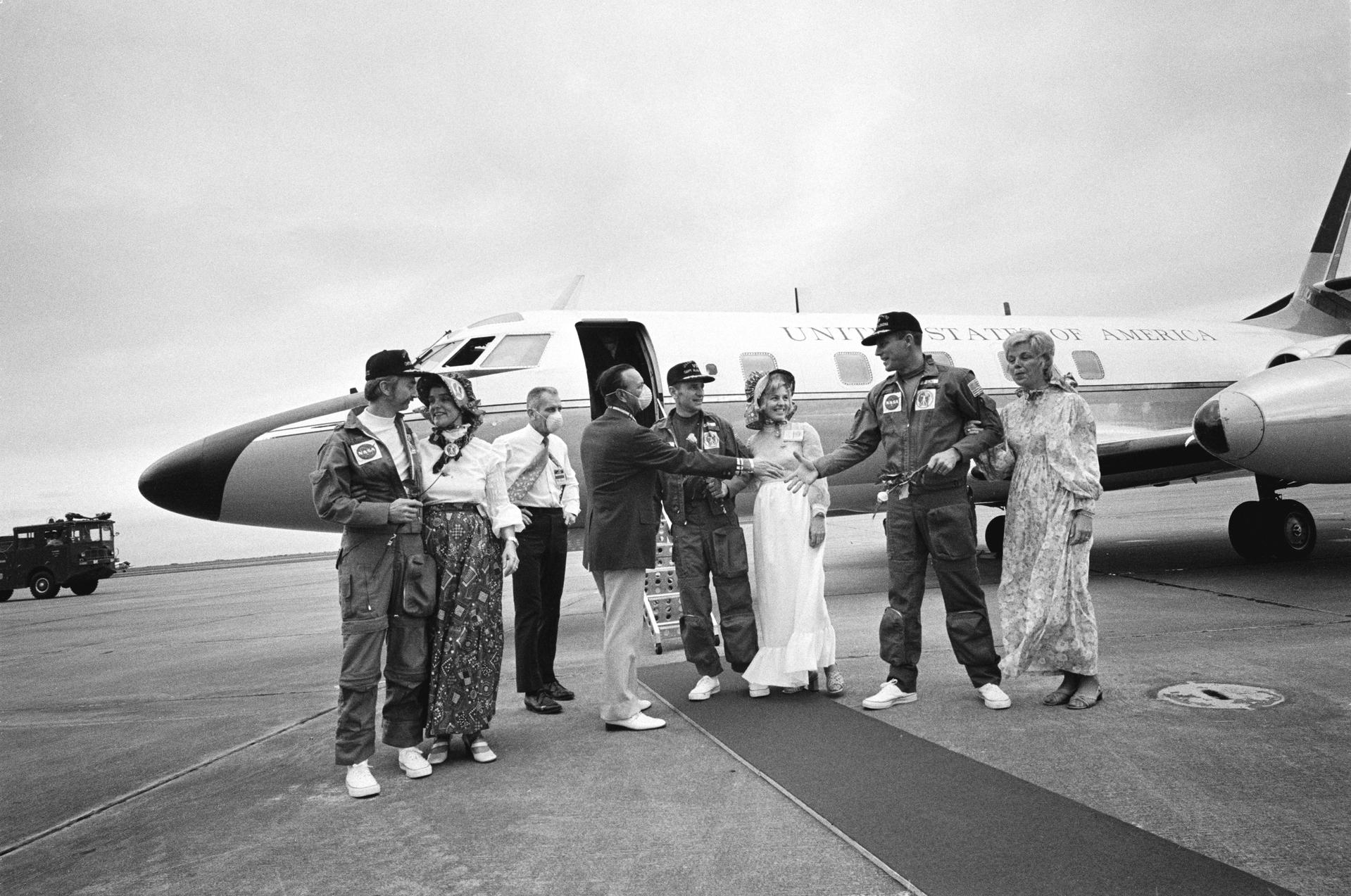 The Skylab 3 crewmembers and their families meet with Dr. Chris C. Kraft in front of an aircraft at Ellington AFB
