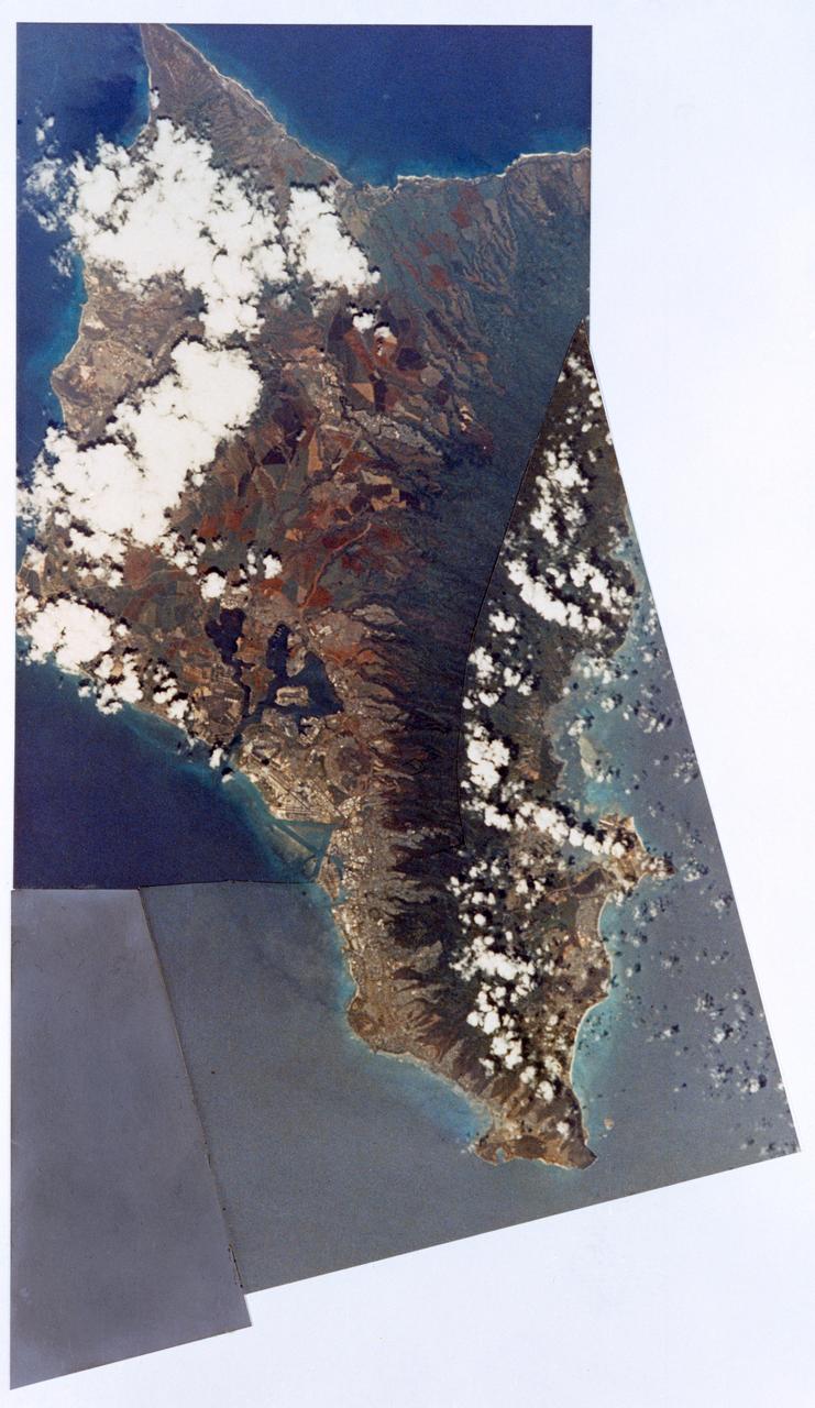 S73-34857 (July-September 1973) --- A composite of two photographs of the Island of Oahu, County of Honolulu, State of Hawaii, taken by one of the Skylab 3 crewmen from the Skylab space station in Earth orbit. The two pictures (SL3-128-3009 and SL3-128-3010) were taken with a hand-held 35mm Nikon camera, a 55/300mm lens and so-368 medium-speed Ektacrome film. Pearl Harbor is clearly visible. The city of Honolulu is located next to the triangle-shaped seaplane runway. Photo credit: NASA