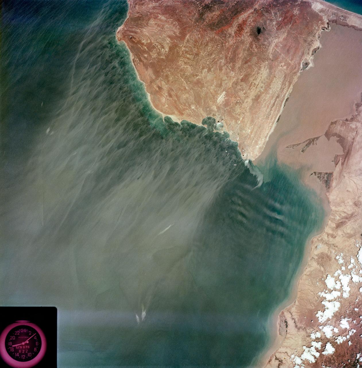 S73-35079 (July-September 1973) --- A near vertical view of the Caribbean coast of Venezuela is seen in this Skylab 3 Earth Resources Experiment Package S190-B (five-inch Earth terrain camera) photograph taken from the Skylab space station in Earth orbit. The large body of water is the Golfo de Venezuela; and the major land mass is the Peninsula de Paraguana. The view is looking northward from the mouth of the Golfete de Coro and Punta Cardon to Punta Macolla. The peninsula is connected to the Venezuelan mainland by the narrow strip of land in the most easterly corner of the picture. The dry, arid climate on the peninsula is indicated by sparse vegetation and the abundance of sand dunes.  The highest point is about 2,700 feet above the sea and is the conspicuous black spot.  Old raised shoreline features appear as streaks parallel to the Golfete de Coro. Sand dunes and stream erosion have modified these features. Water of the Golfete de Coro is red from the high sediment content. The streaks in the water off the peninsula is apparently an effect of wind which is blowing sand and water offshore. The EREP investigator Dr. Jose Antonio Galavis, of the Ministerio de Mines e Hidrocarburos, will use this information to map geology and coastal sedimentation in the Peninsula de Paraguana. Federal agencies participating with NASA on the EREP projects are the Departments of Agriculture, Commerce, Interior, the Environmental Protection Agency and the Corps of Engineers. All EREP photography is available to the public through the Department of Interior?s Earth Resources Observations Systems Data Center, Sioux Falls, South Dakota, 57198. (Alternate number SL3-83-237) Photo credit: NASA