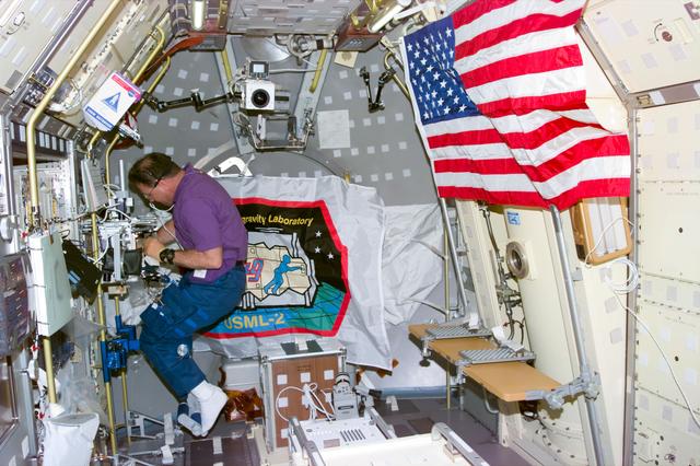 NASA image: PCG-GBX, Payload Specialist Albert Sacco works at glovebox