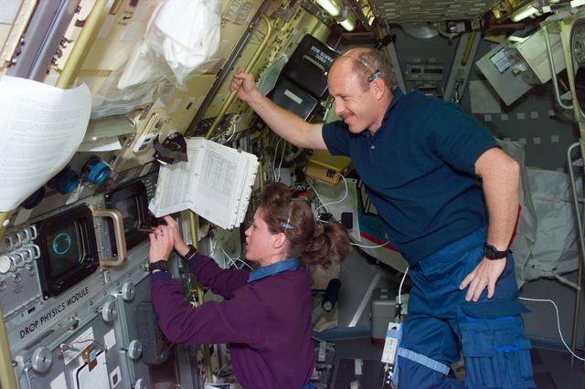 NASA image: DPM, Payload Commander Kathy Thornton works with experiment as Bowersox watches