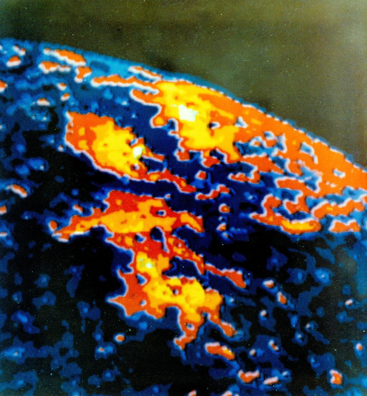 S74-21921 (For release 1974) --- Sun photographed by Apollo Telescope Mount through spectroheliometer at a wavelength of 625.3 angstroms. The black areas are the surface of the sun; the reds, yellows and whites are the corona some 70,000 kilometers above the surface. Photo credit: NASA