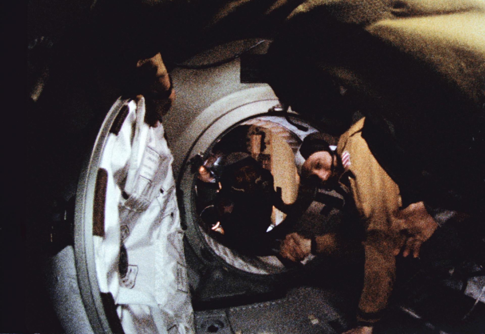 Tom Stafford and Aleksei Leonov shake hands in space