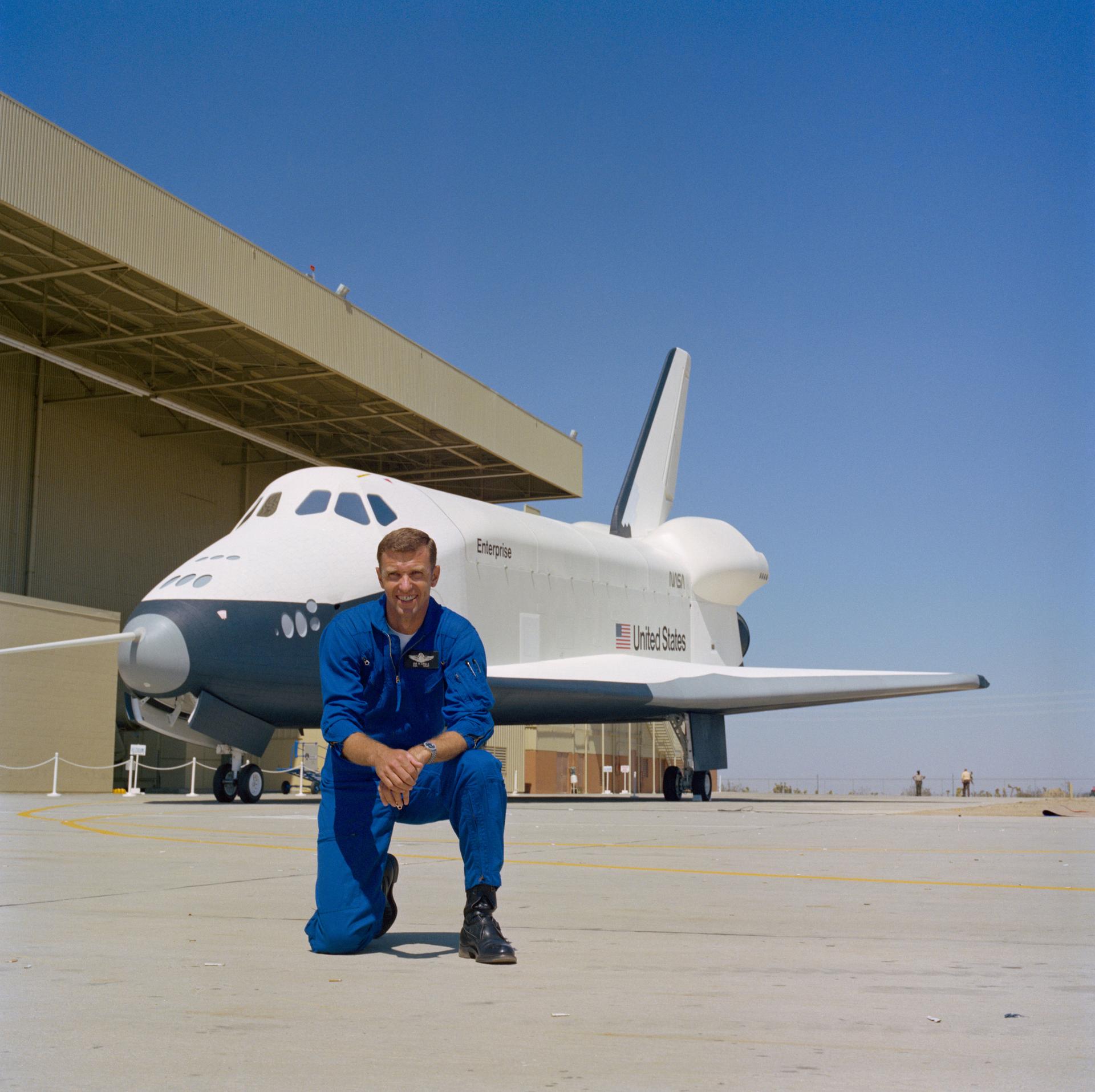 Joe Engle poses with the Shuttle Orbiter 101 on the event of its rollout
