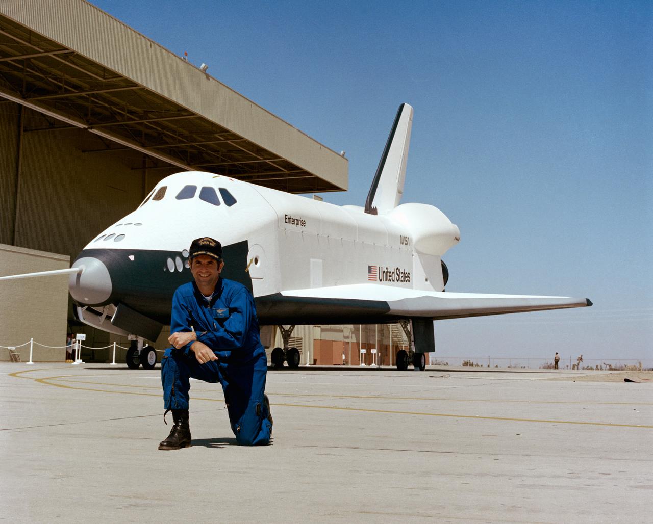 S76-29569 --- Astronaut Richard H. Truly, pilot of the second crew for the Space Shuttle Approach and Landing Tests (ALT), is photographed at the Rockwell International Space Division's Orbiter assembly facility at Palmdale, California on the day of the rollout of the Shuttle Orbiter 101 "Enterprise" spacecraft. The DC-9 size airplane-like Orbiter 101 is in the background. 