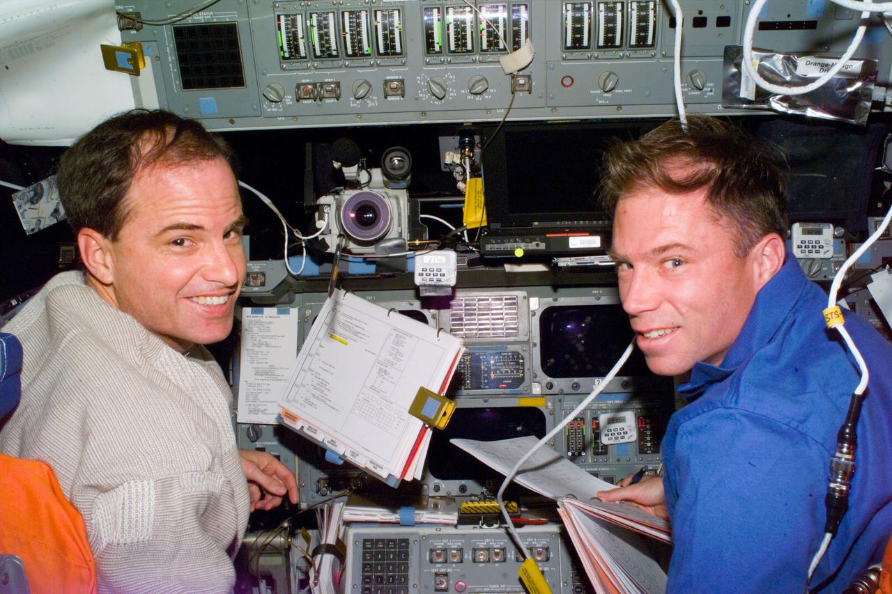 S76-E-5138 (24 March 1996) --- Astronauts Kevin P. Chilton (left) and Richard A. Searfoss man the commander and pilot stations, respectively, for the rendezvous and docking procedures with Russia's Mir Space Station.  The image was recorded with a 35mm Electronic Still Camera (ESC) and downlinked at a later time to ground controllers in Houston, Texas.
