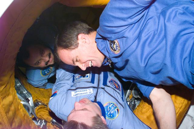 NASA image: Commander Kevin Chilton is greeted as he moves past the APAS interface