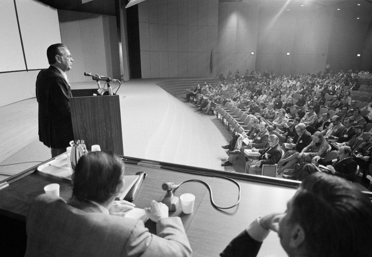 S77-22482 (14 March 1977) --- Johnson Space Center Director Christopher C. Kraft Jr. addresses a crowd of scientists and news media representatives at the opening of the Eighth Annual Lunar Science Conference in the Teague Auditorium.  Photo credit: NASA