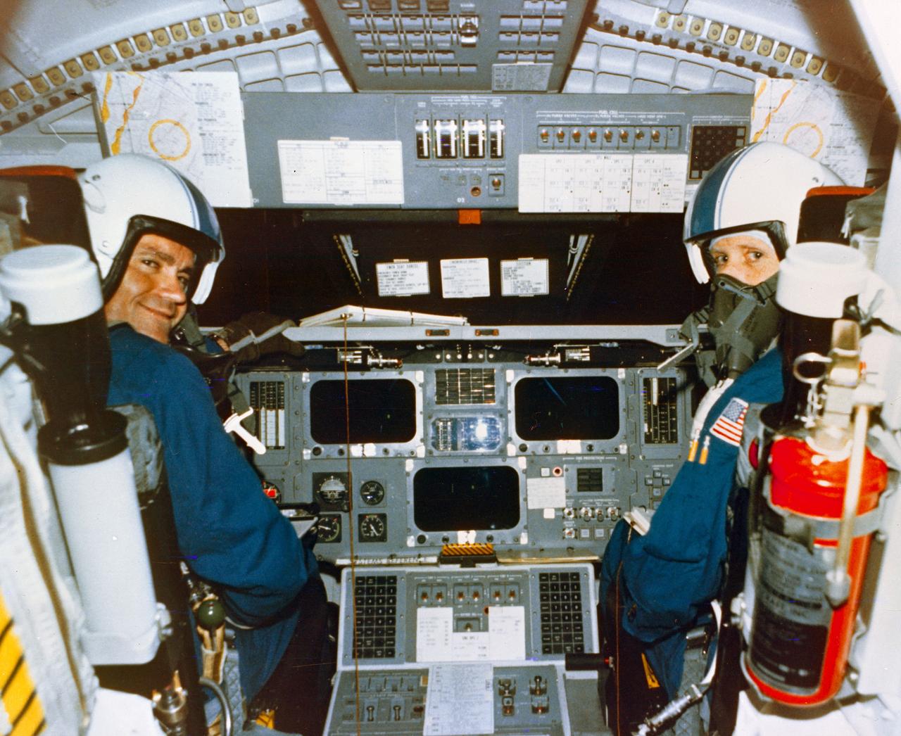 Astronauts Fred W. Haise, Jr., Commander, left, and C. Gordon Fullerton in the cockpit of the Space Shuttle Orbiter 101 "Enterprise" prior to the fifth and final FF in the Approach and Landing Test (ALT) series, from DFRC.  Original photo number was 77-HC-446.        DFRC, CA