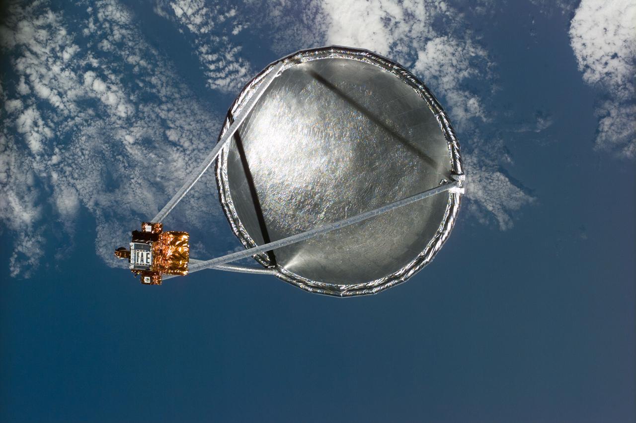 S77-E-5022 (20 May 1996)--- Following its deployment from the Space Shuttle Endeavour, the Spartan 207/Inflatable Antenna Experiment (IAE) payload is backdropped over clouds and water.  The view was photographed with an Electronic Still Camera (ESC) and downlinked to flight controllers on the first full day of orbital operations by the six-member crew.  Managed by Goddard Space Flight Center (GSFC), Spartan is designed to provide short-duration, free-flight opportunities for a variety of scientific studies.  The Spartan configuration on this flight is unique in that the IAE is part of an additional separate unit which is ejected once the experiment is completed.  The IAE experiment will lay the groundwork for future technology development in inflatable space structures, which will be launched and then inflated like a balloon on-orbit.
