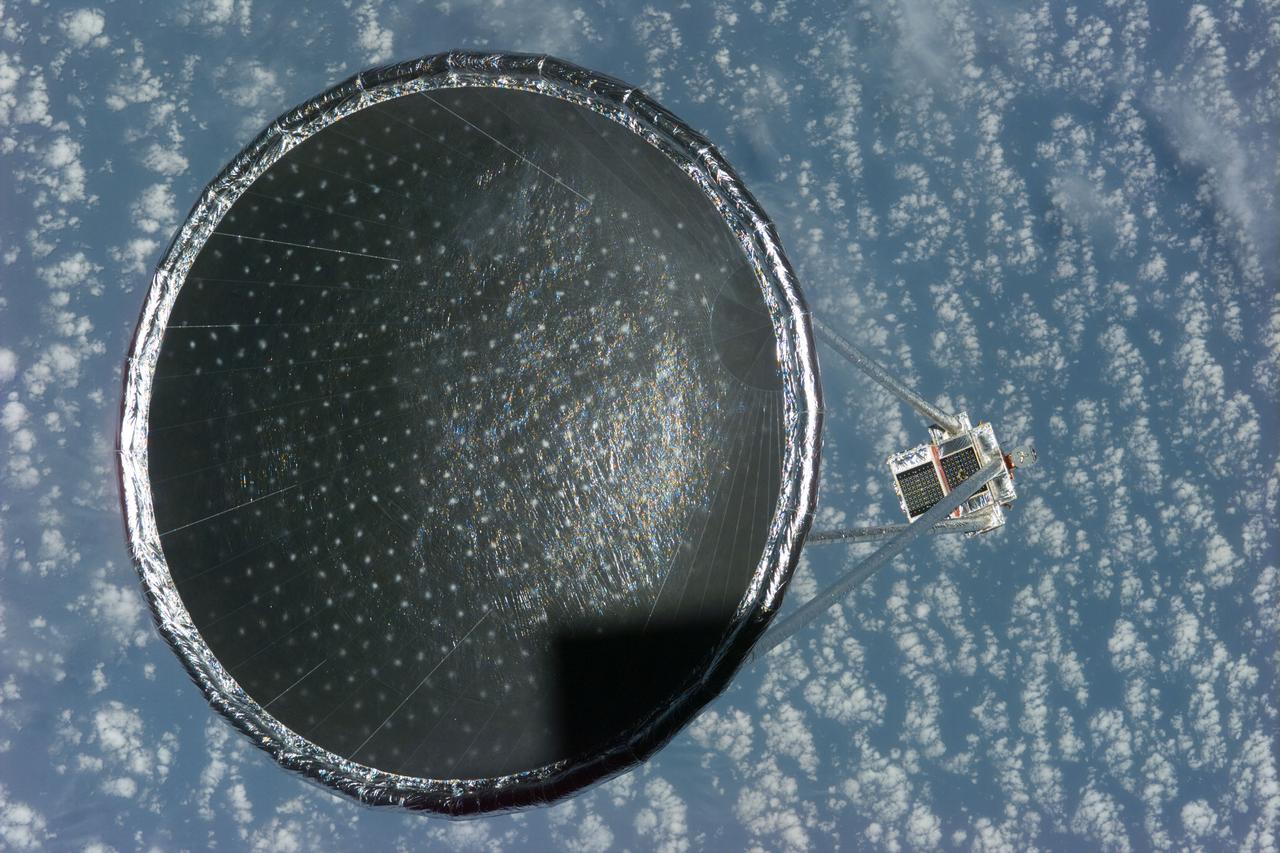 S77-E-5027 (20 May 1996)--- Following its deployment from the Space Shuttle Endeavour, the Spartan 207/Inflatable Antenna Experiment (IAE) payload is backdropped over clouds and water.  The view was photographed with an Electronic Still Camera (ESC) and downlinked to flight controllers on the first full day of orbital operations by the six-member crew.  Managed by Goddard Space Flight Center (GSFC), Spartan is designed to provide short-duration, free-flight opportunities for a variety of scientific studies.  The Spartan configuration on this flight is unique in that the IAE is part of an additional separate unit which is ejected once the experiment is completed.  The IAE experiment will lay the groundwork for future technology development in inflatable space structures, which will be launched and then inflated like a balloon on-orbit.