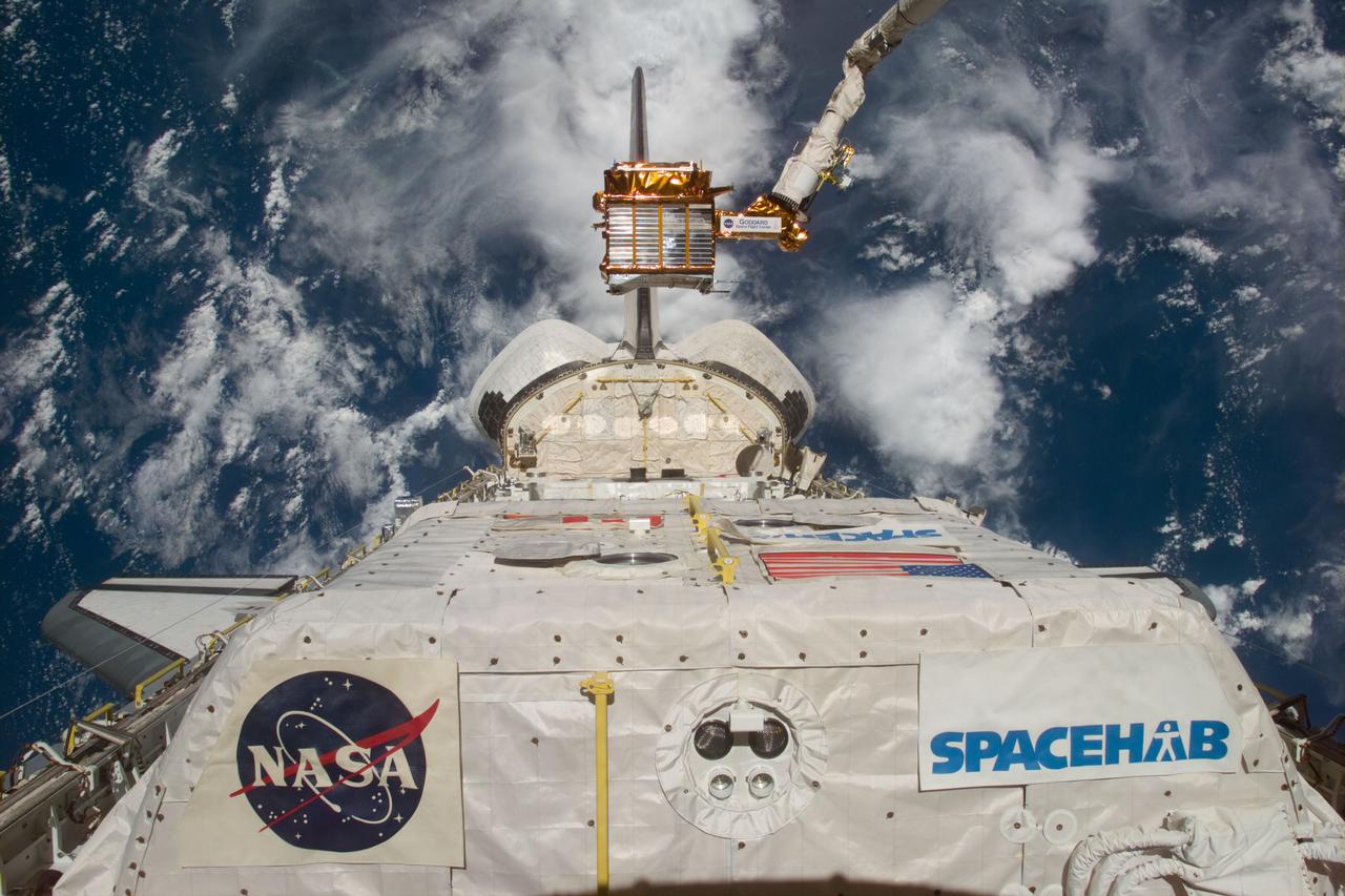 S77-E-5053 (21 May 1996) --- The Spartan 207 free-flyer is held in a low-hover mode above its berth in the Space Shuttle Endeavour's cargo bay in the grasp of the Remote Manipulator System (RMS).  The Spacehab module can be seen in the foreground.  The free-flyer was re-captured by the six crew members on May 21, 1996.  The crew has spent a portion of the early stages of the mission in various activities involving the Spartan 207 and the related Inflatable Antenna Experiment (IAE).  The Spartan project is managed by NASA's Goddard Space Flight Center (GSFC) for NASA's Office of Space Science, Washington, D.C.