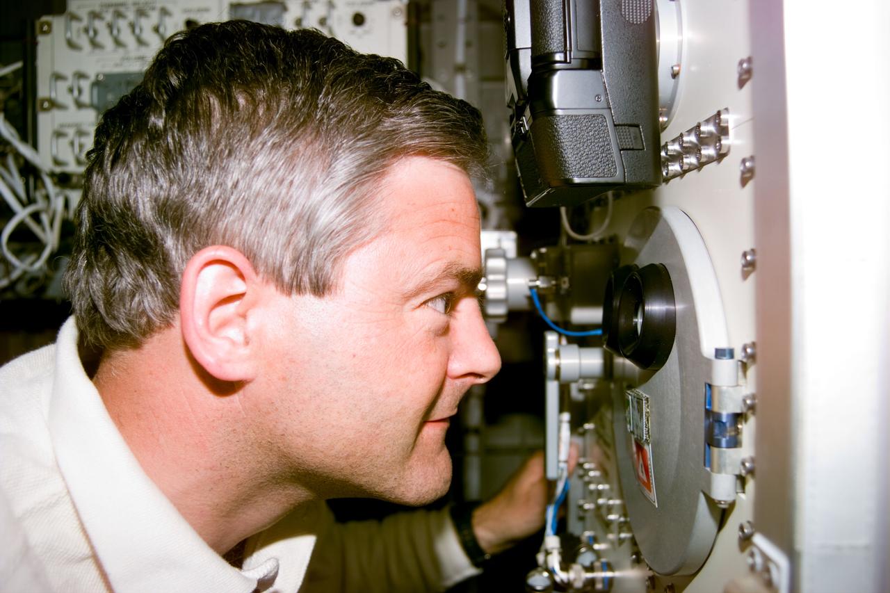 S77-E-5093 (25 May 1996) --- Astronaut Marc Garneau, mission specialist representing the Canadian Space Agency (CSA), makes a visual check of the Commercial Float Zone Furnace (CFZF), a single-rack-mounted facility in the Spacehab Module onboard the Earth-orbiting Space Shuttle Endeavour.  The scene was recorded with an Electronic Still Camera (ESC).
