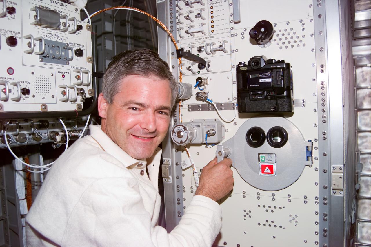 S77-E-5094 (25 May 1996) --- Astronaut Marc Garneau, mission specialist representing the Canadian Space Agency (CSA), stands at the Commercial Float Zone Furnace (CFZF) in the Spacehab Module onboard the Earth-orbiting Space Shuttle Endeavour.