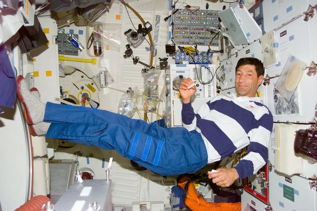 NASA image: Runco on middeck during meal