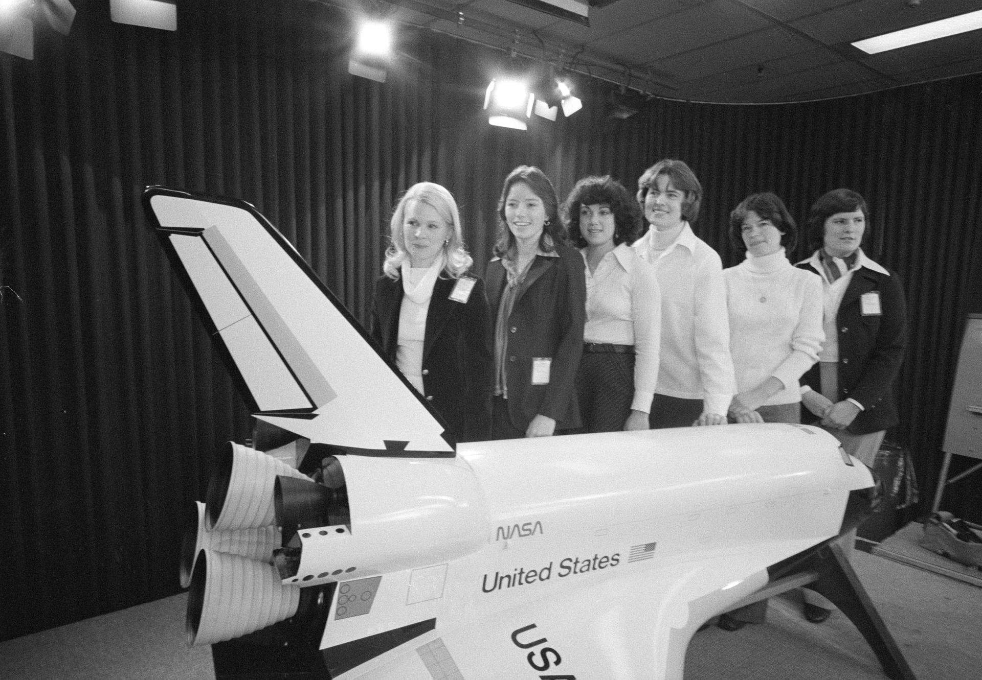 6 female astronaut candidates pose with a model shuttle