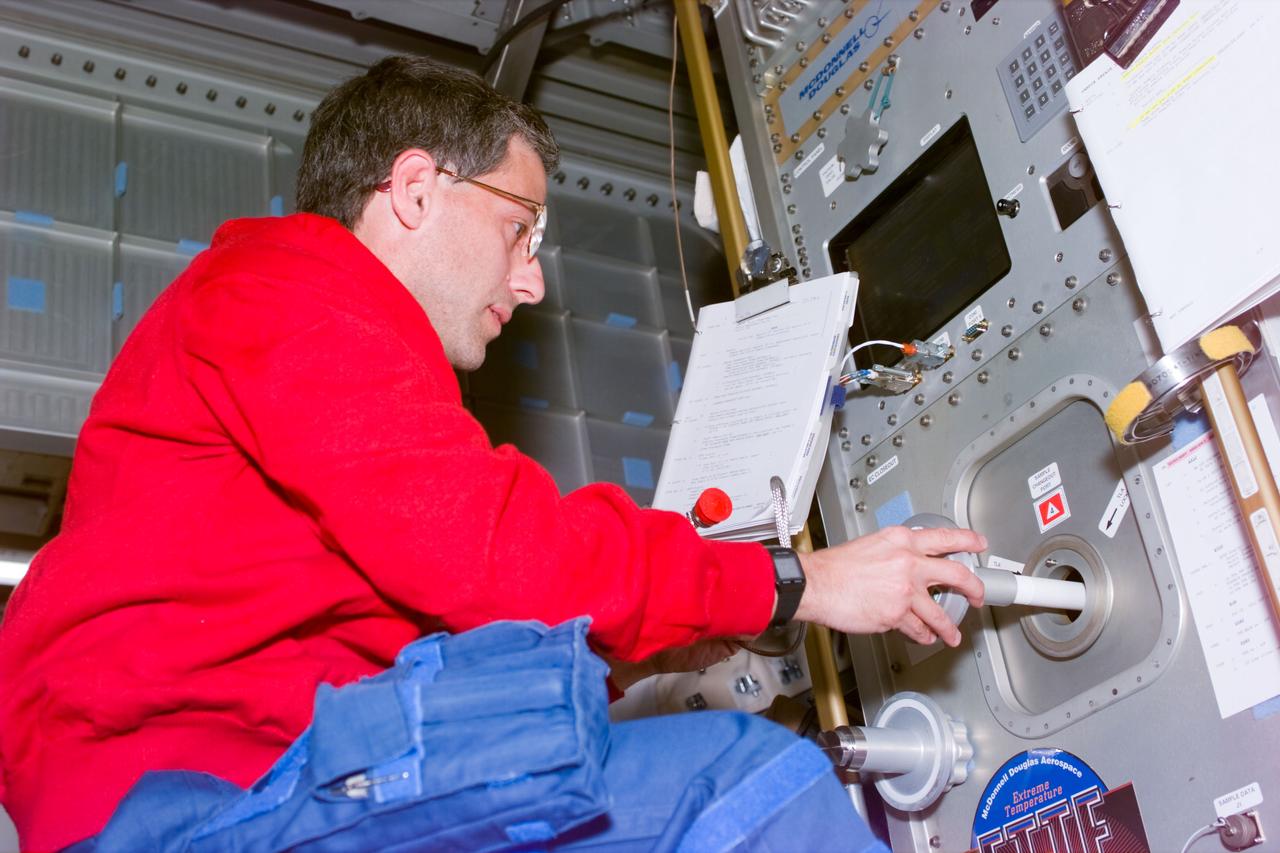 STS79-E-5019 (17 September 1996) --- Astronaut Jerome (Jay) Apt inserts experiment into Extreme Temperature Translation Furnace (ETTF) furnace, onboard the Space Shuttle Atlantis, on Flight Day 2.