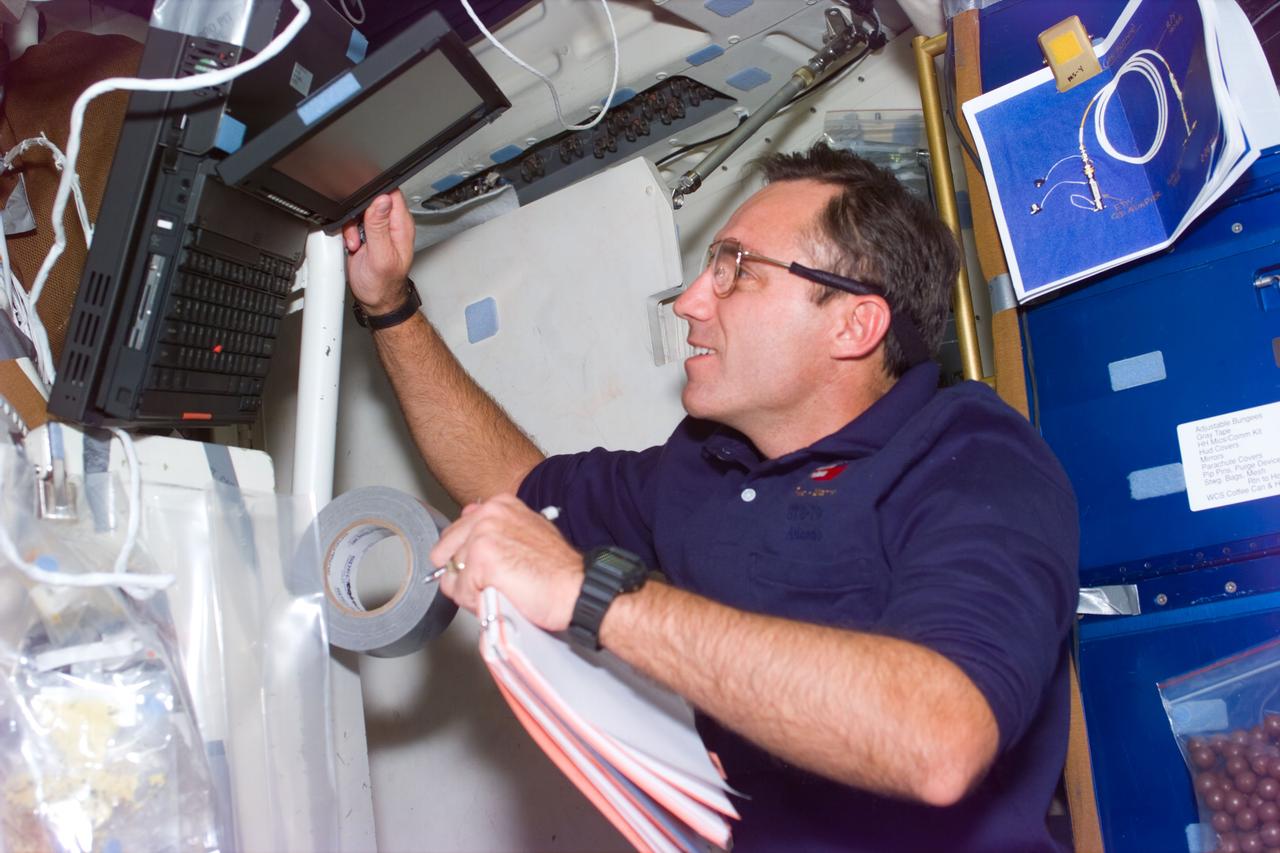 STS79-E-5024 (18 September 1996) --- Carl E. Walz, mission specialist, aligns computer to assist in an experiment in Spacehab Module, on Flight Day 3.