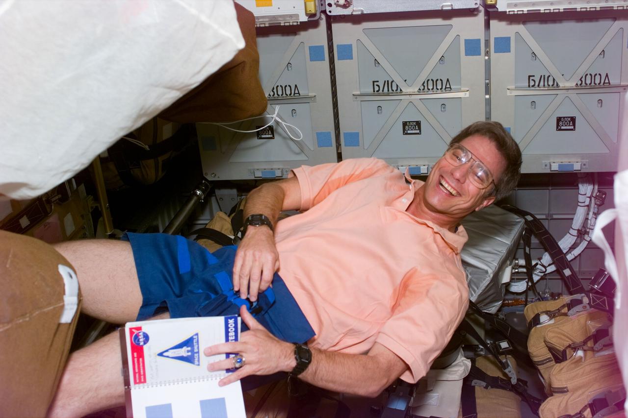 STS79-E-5027 (18 September 1996) --- Astronaut John E. Blaha, near Spacehab lockers onboard the Space Shuttle Atlantis, stays busy with final preparations for joining cosmonauts for crew mates following tomorrow's docking of the Atlantis and Russia's Mir Space Station, on Flight Day 3.
