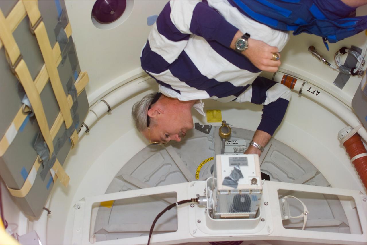 STS-79 mission commander William F. Readdy checks the center-line docking camera in the orbiter docking system (ODS) during flight day 3. The camera will be used on flight day 4 to line up the Atlantis for its docking with the Mir space station.