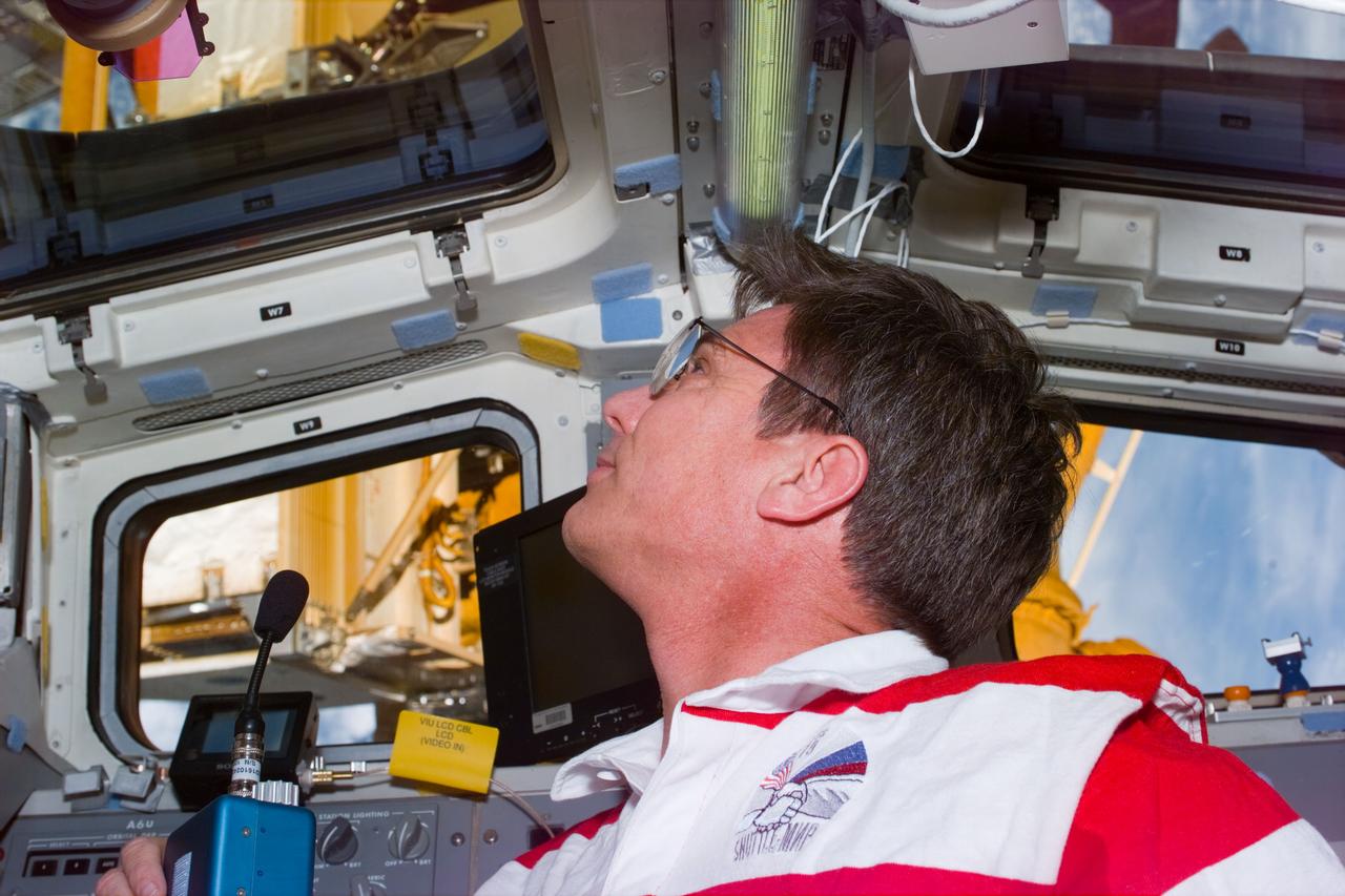 STS79-E-5059 (19 September 1996) --- Astronaut John E. Blaha, soon to join the Mir-22 crew aboard Russia's Mir Space Station as a cosmonaut guest researcher, looks through the Space Shuttle Atlantis' aft flight deck windows toward his new temporary home, on Flight Day 4.