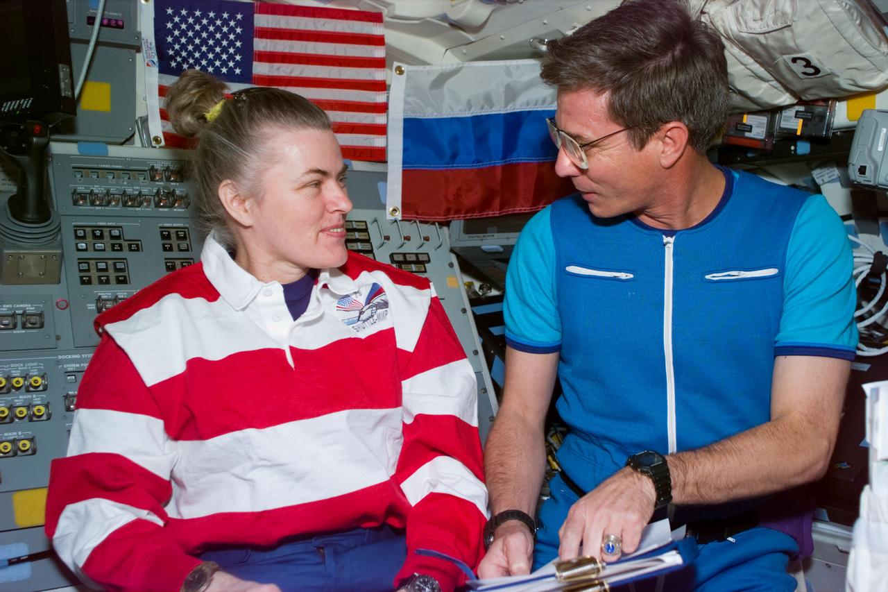 STS79-E-5131 (20 September 1996) --- Astronauts Shannon W. Lucid and John E. Blaha, sharing a third flight together in Earth-orbit (twice on the Space Shuttle Atlantis, once on the Space Shuttle Columbia), hold a brief-debrief session about their soon-to-be exchanged roles, during Flight Day 5.  Blaha becomes a Mir-22 cosmonaut guest researcher for several months and Lucid ends a period of over six months aboard Mir as a cosmonaut guest researcher, having spent time with two Mir crews.