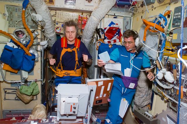 NASA image: Astronaut Lucid on treadmill while Blaha performs daily planning