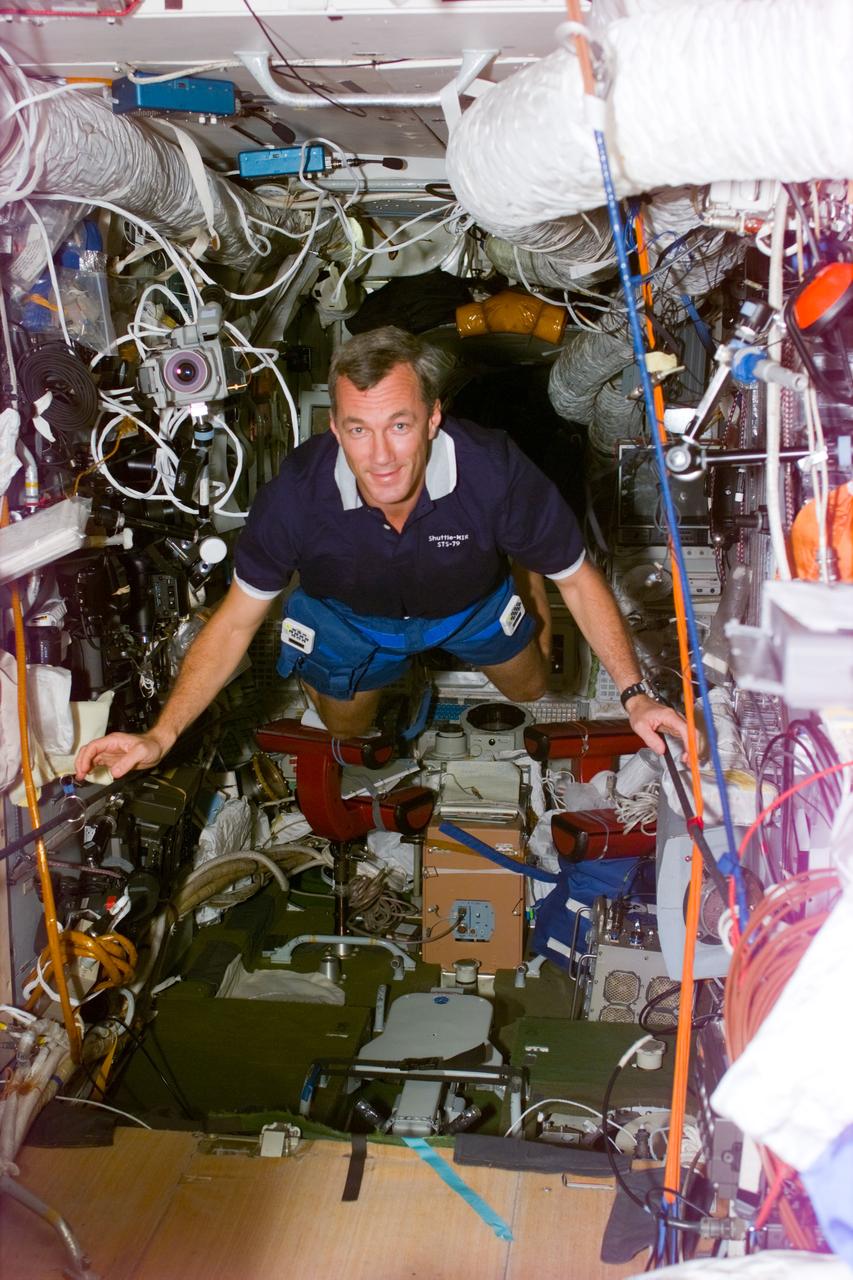 STS79-E-5198 (21 September 1996) --- Astronaut Terrence W. Wilcutt, STS-79 pilot, floats through Russia's Mir Space Station Base Block Module, during Flight Day 6.
