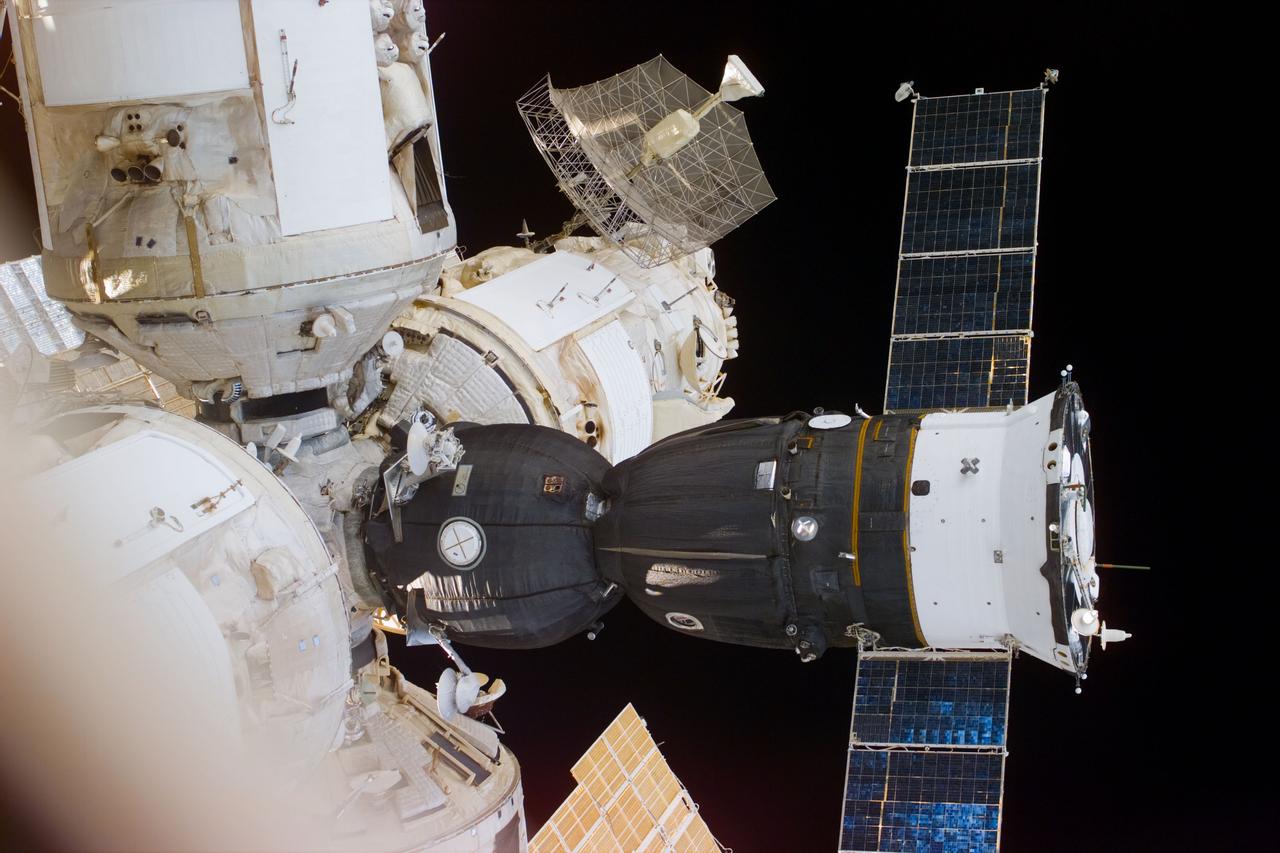 STS79-E-5216 (21 September 1996) --- A Space Shuttle Atlantis out-the-window view showing a Soyuz spacecraft docked with Russia's Mir Space Station, during Flight Day 6.
