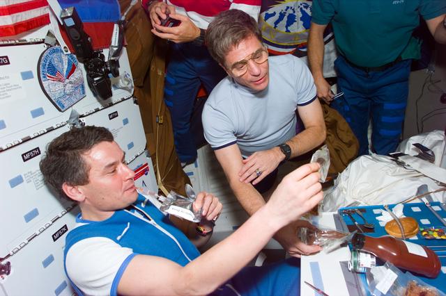 NASA image: STS-79 and Mir 22 crew share a barbecue dinner on the middeck