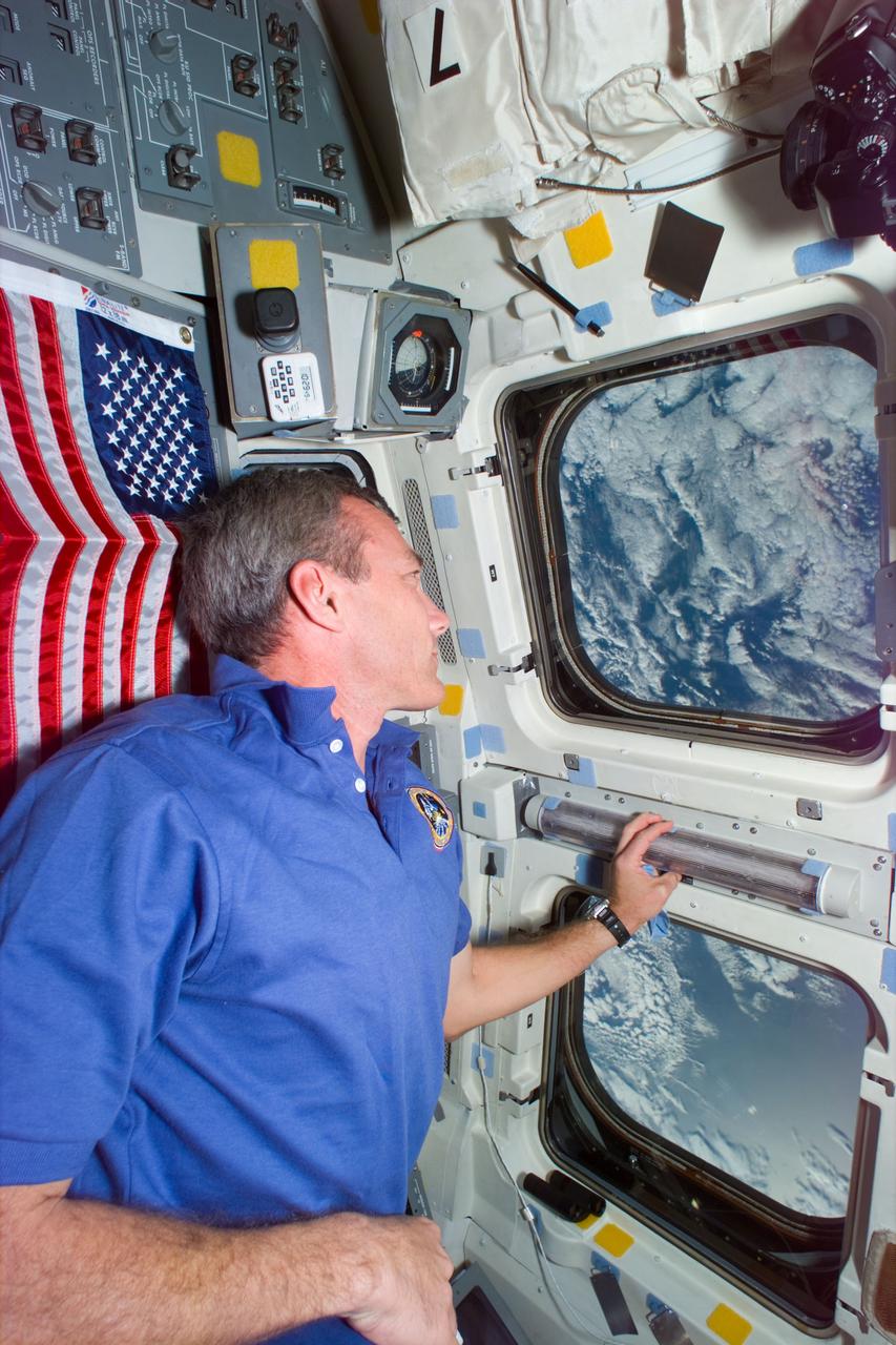 STS79-E-5379 (24 September 1996) --- Astronaut Terrence W. Wilcutt, pilot, watches the Russia's Mir Space Station, with fellow astronaut John E. Blaha, cosmonaut guest researcher onboard, gradually getting further and further away from the Space Shuttle Atlantis, during Flight Day 9.