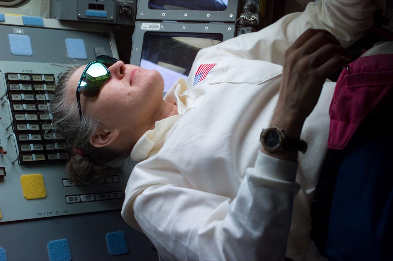 STS79-E-5388 (16 - 26 September 1996)   --- Astronaut Shannon W. Lucid, former cosmonaut guest researcher, was photographed onboard the Space Shuttle Atlantis as the Russian Mir Space Station, her temporary &quot;home&quot; for the past six months, moves off to continue its mission with fellow astronaut John E. Blaha, cosmonaut guest researcher, aboard.