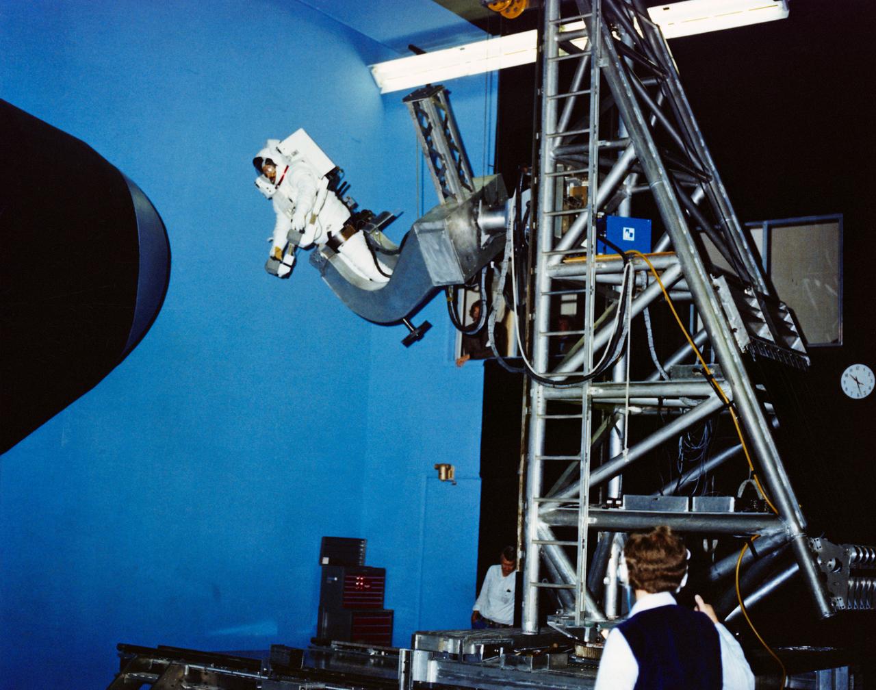 S80-36848 (24 July 1980) --- Photo of the Manned Maneuvering Unit (MMU) simulator at the Martin Marietta plant in Denver, Colorado. View of simulator with test subject strapped in to it.