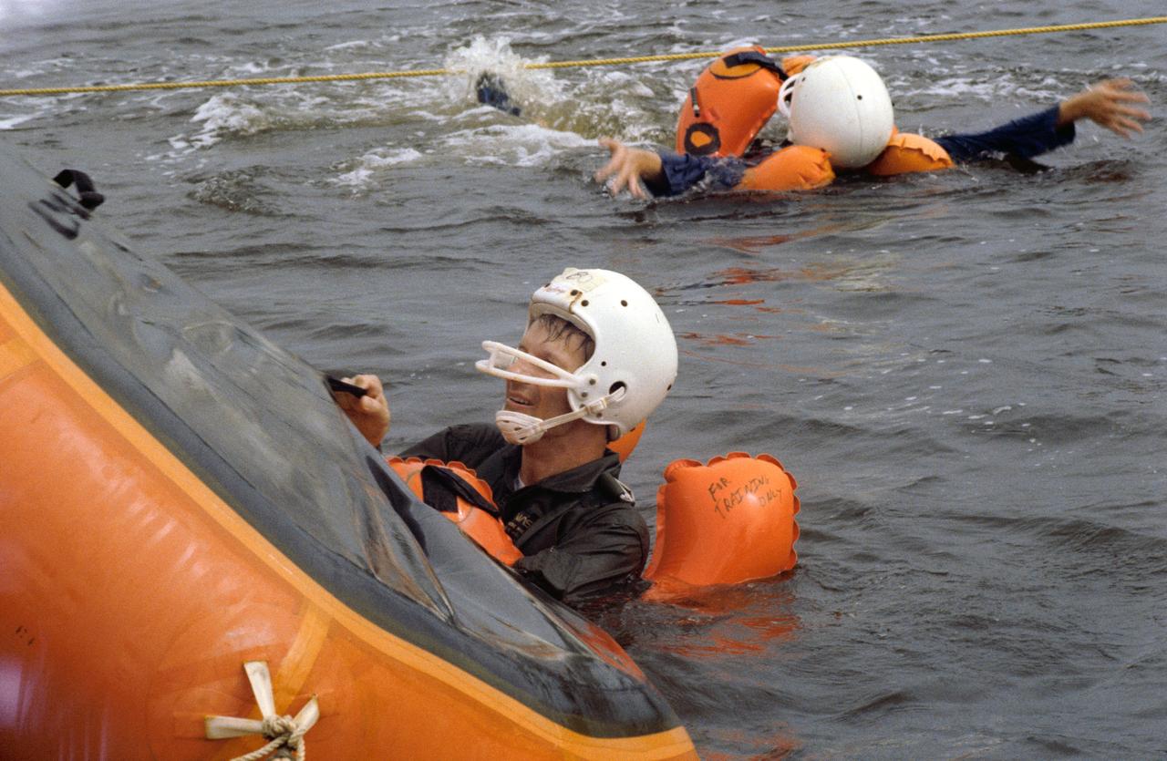 S80-38456 (13 Aug 1980) --- Claude Nicollier of Switzerland, one of two European scientists/Spacelab payload specialist candidates training in the United States along with 19 new NASA astronaut candidates, grabs onto the one-man life raft he is using during a water survival training school attended by several JSC personnel in mid-August. Six of the 19 candidates who had not had this type training before and the two Europeans were joined by a veteran astronaut, training personnel and two NASA physicians on the trip.