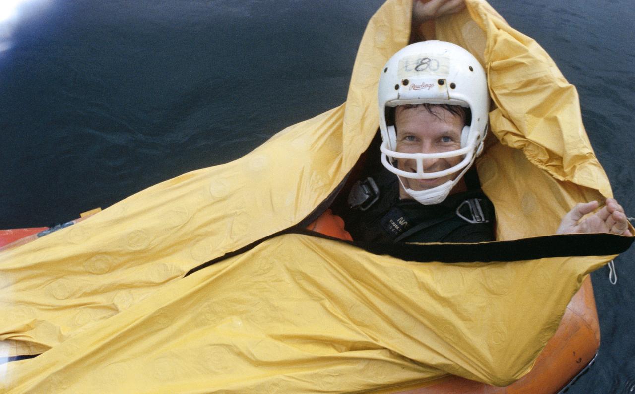 S80-38468 (4 Sept 1980) --- Astronaut Claude Nicollier in water egress training. View is of Nicollier in one-man life raft.