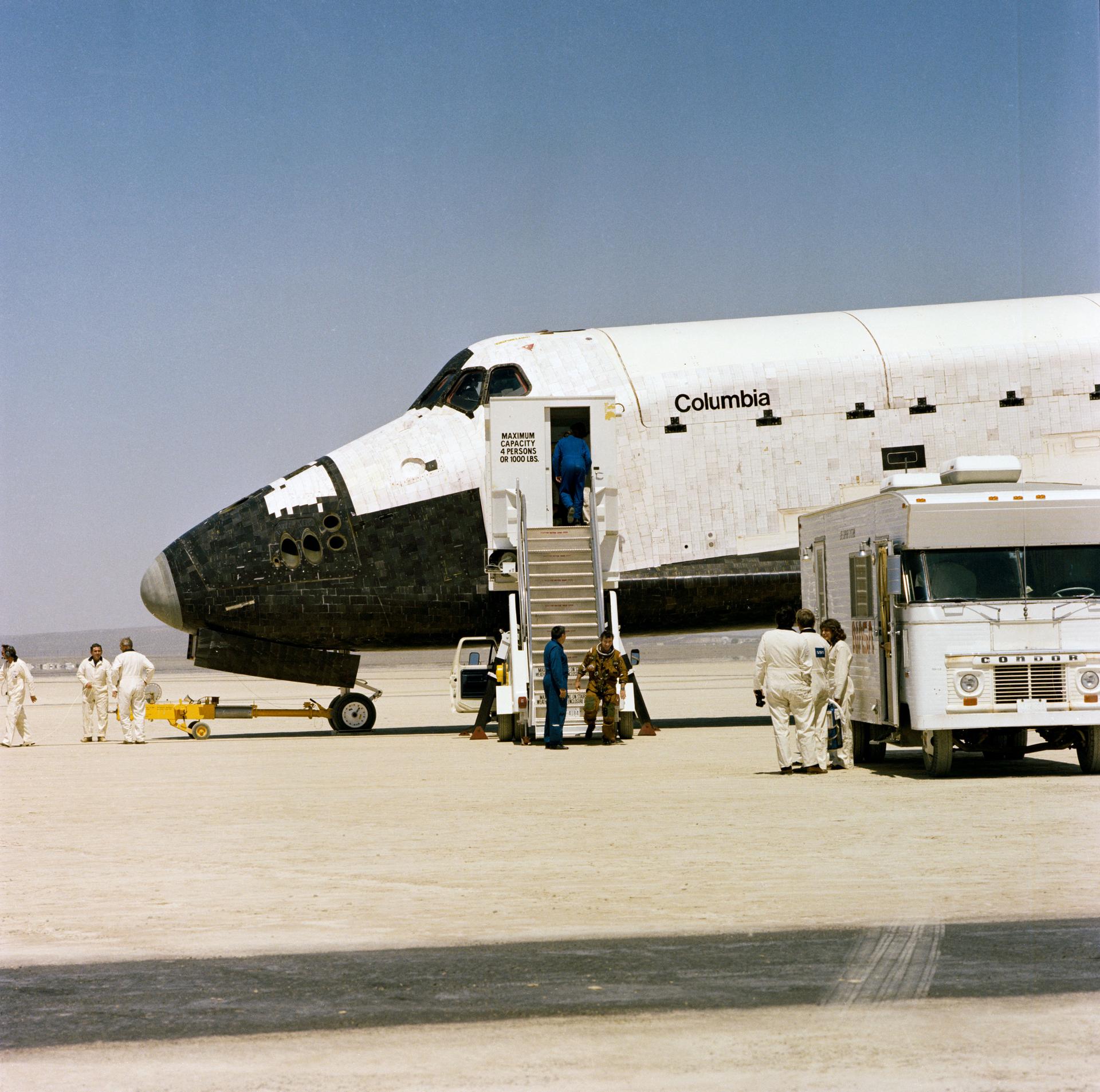 People stand near STS-1 space shuttle Columbia after it lands from its first mission