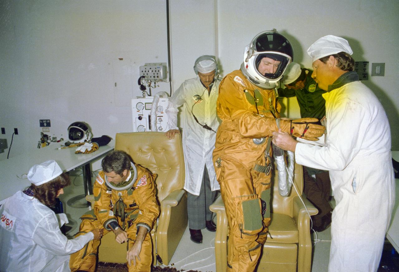 S81-38547 (10 Sept. 1981) --- Astronauts Joe H. Engle, right, and Richard H. Truly, prime crew members for STS-2, complete their suiting up chores prior to a countdown demonstration test (CDDT). They are in the operations and checkout building at the Kennedy Space Center. The two have a launch scheduled for late autumn of this year. Photo credit: NASA