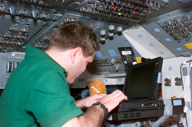 NASA image: MS Grunsfeld on flight deck with PGSC