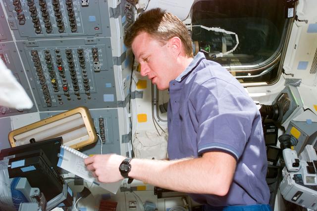 NASA image: Pilot Jett reviews checklist on flight deck