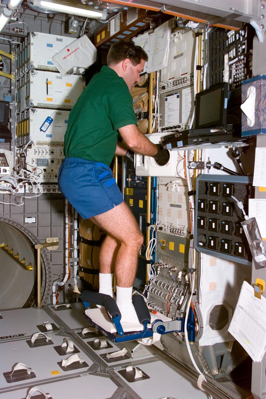 STS81-E-05107 (13 Jan. 1997) --- Astronaut John M. Grunsfeld, mission specialist, begins to activate a biorack glovebox aboard the Spacehab Double Module (DM) early on Day 2 of the mission.  Grunsfeld is joined by five other NASA astronauts for the almost ten-day mission. The crew is scheduled to dock with Russia's Mir Space Station and pick up John E. Blaha, NASA astronaut who has been serving as a cosmonaut guest researcher since September 1996. Jerry M. Linenger (out of frame) will replace Blaha onboard Mir.