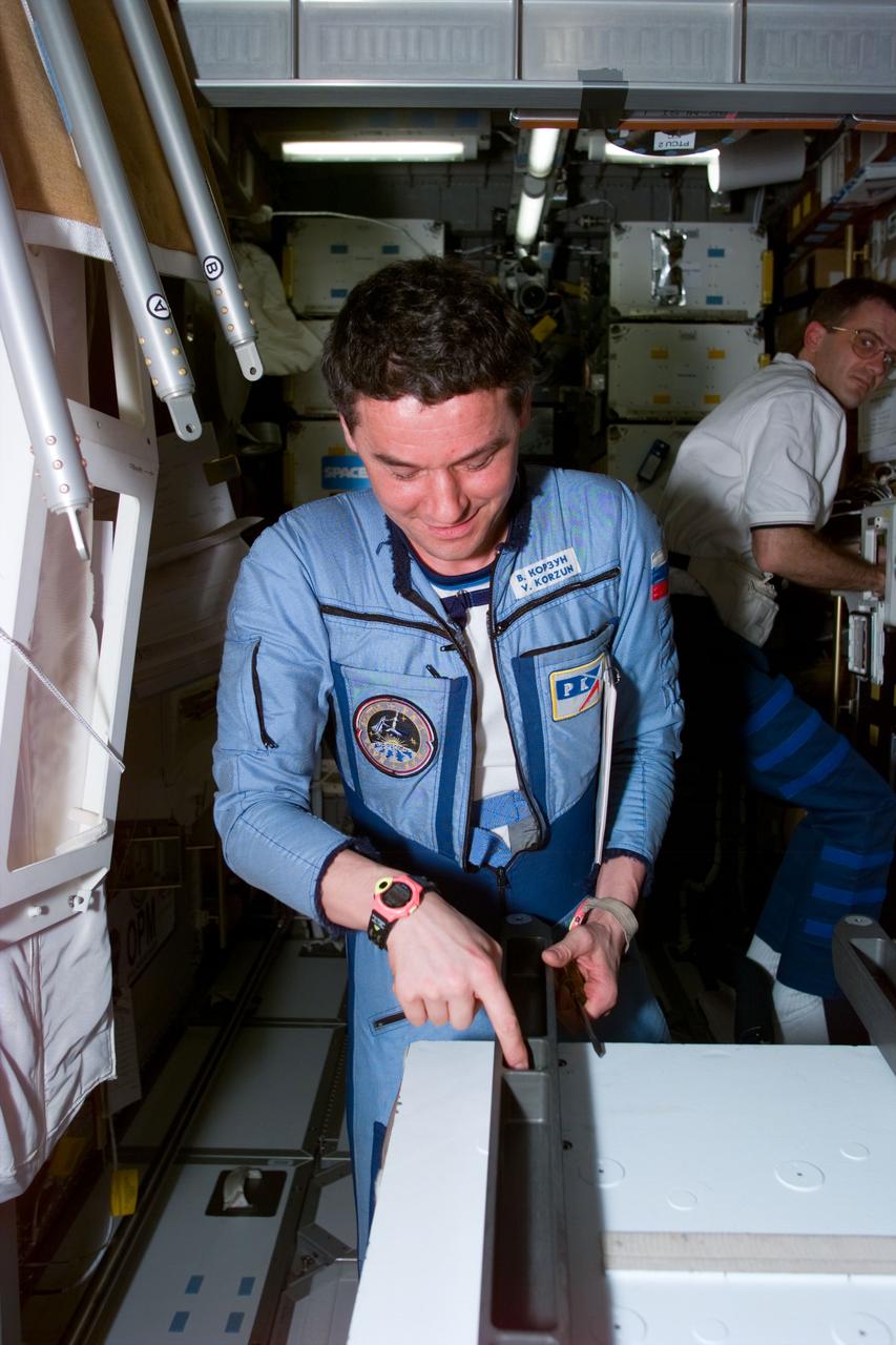 STS081-E-05477 (16 Jan. 1997) --- In the Spacehab Double Module (DM), cosmonaut Valeri G. Korzun, Mir-22 commander, checks out the rails for a Russian Mir Space Station experiment called ALICE. The experiment is a cooperative project between France's Space Agency (CNES) and the Russian Space Agency (RSA). The photograph was recorded with an Electronic Still Camera (ESC) and later was downlinked to flight controllers in Houston, Texas.