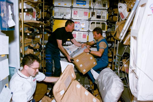 NASA image: STS-81 crew packs hardware for stowage in the Spacehab