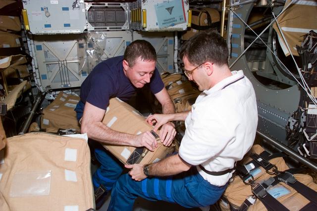 NASA image: STS-81 crew packs hardware for stowage in the Spacehab