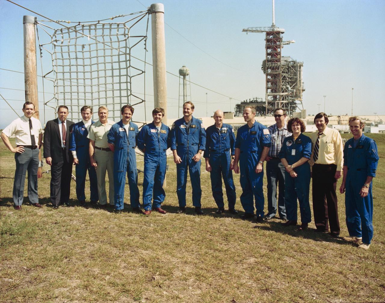 S82-28457 (19 Feb. 1982) --- Member of the JSC astronaut corps., STS-3 vehicle integration test (VIT) team and other personnel pose for a photograph at the completion of a countdown demonstration test (CDDT) and safety briefings at Launch Pad 39A, Kennedy Space Center (KSC). Participants are, from the left, Wilbur J. Etbauer, engineer with the VIT team; George W. S. Abbey, director of flight operations at JSC; astronaut John W. Young, chief of the astronaut office at JSC; Jack Fleming of Rockwell International; mission specialist-astronaut John M. Lounge; astronaut Daniel C. Brandenstein; mission specialist-astronaut James D. Van Hoften; astronauts C. Gordon Fullerton and Jack Lousma, prime crew for STS-3; Olan J. Bertrand, VIT team member; mission specialist-astronaut Kathryn D. Sullivan; Richard W. Nygren, head of the VIT team; and astronaut Donald E. Williams. The space shuttle Columbia is obscured by its service structure on Launch Pad 39A in the background. Part of slide-wire type emergency escape system is visible in the picture. Photo credit: NASA